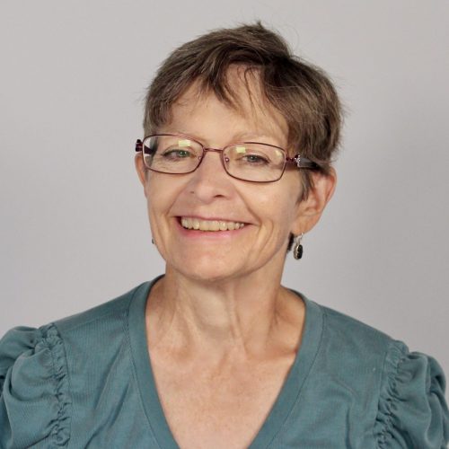 Headshot of Kari McLean, smiling and wearing glassess